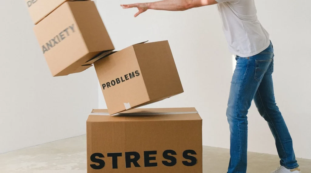Cropped image of man pushing boxes that represents strees, problems and anxiety